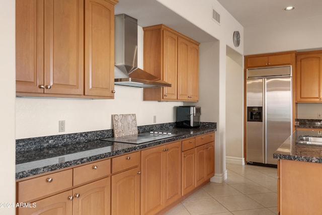 15972 N 115th Way, Scottsdale, AZ 85255 - kitchen featuring built in refrigerator, wall chimney exhaust hood, black electric stovetop, light tile patterned floors, and dark stone countertops