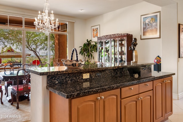 15972 N 115th Way, Scottsdale, AZ 85255 - kitchen with a chandelier, dark stone countertops, and decorative light fixtures