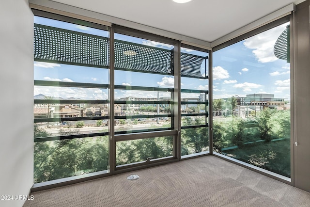 unfurnished sunroom featuring a view of city