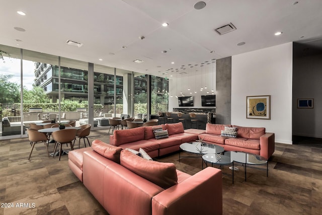 living room with visible vents, a wall of windows, and recessed lighting