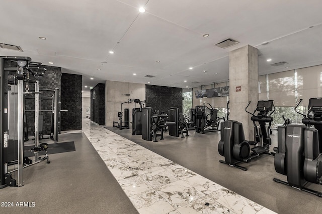 gym featuring visible vents, a wall of windows, and recessed lighting