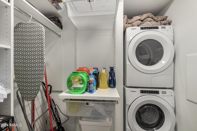 washroom with stacked washer / dryer and laundry area