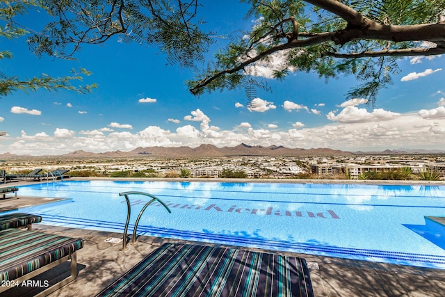 community pool with a mountain view