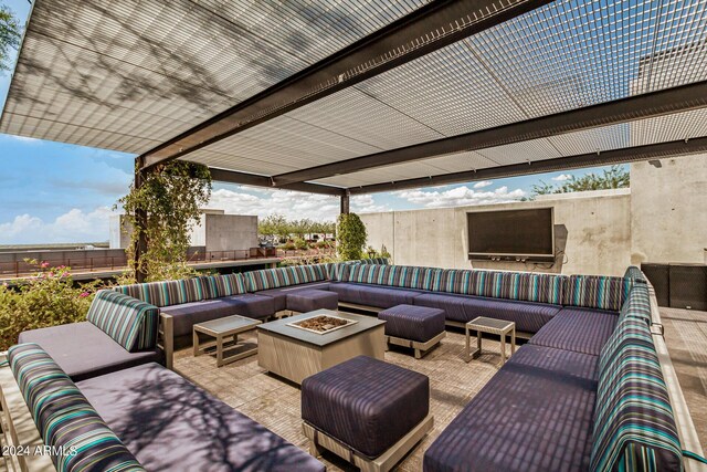 view of patio with an outdoor living space with a fire pit