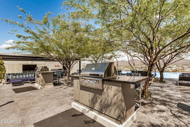 view of patio / terrace with outdoor dining space, a grill, and area for grilling