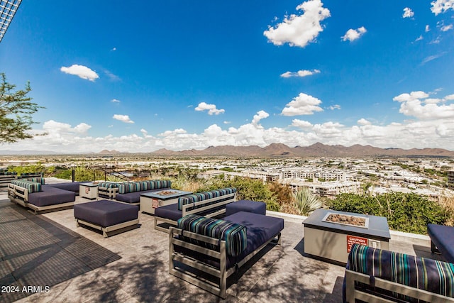 exterior space with an outdoor living space with a fire pit and a mountain view