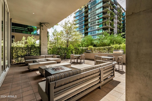 view of patio featuring an outdoor living space with a fire pit