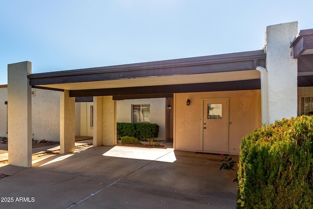 doorway to property with a carport