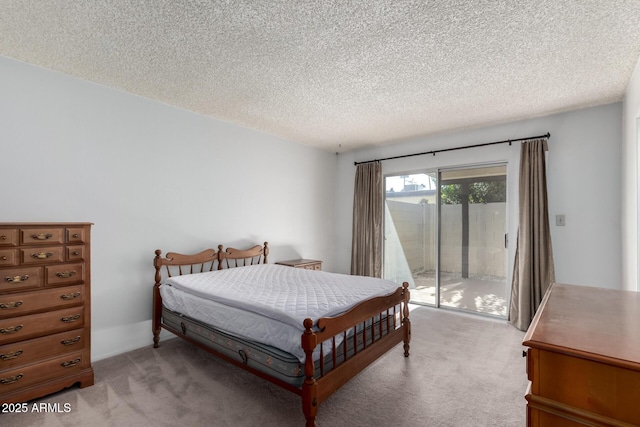 bedroom with light carpet, access to exterior, and a textured ceiling