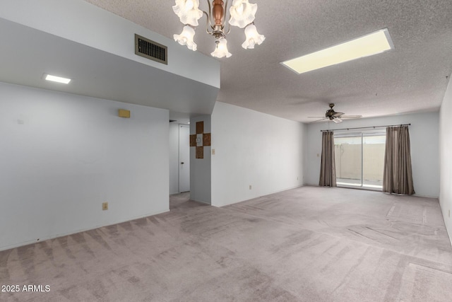 unfurnished room featuring ceiling fan with notable chandelier, light carpet, and a textured ceiling