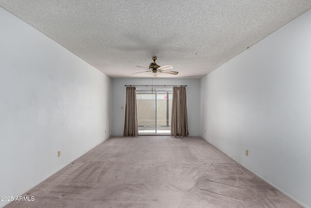 unfurnished room with ceiling fan, light colored carpet, and a textured ceiling