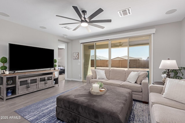 living room featuring ceiling fan and wood-type flooring