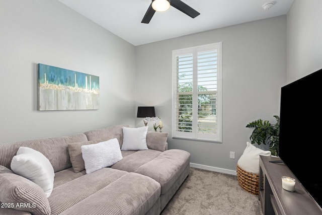 carpeted living room with ceiling fan