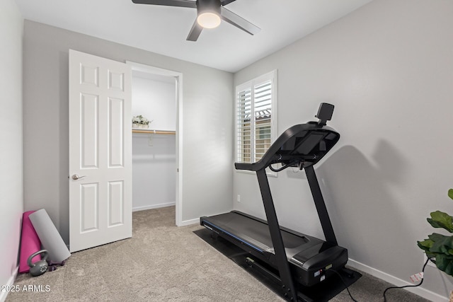 exercise area featuring ceiling fan and light colored carpet