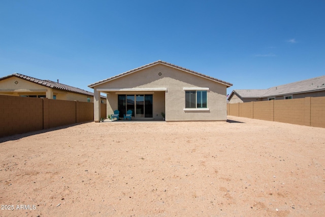 rear view of property featuring a patio area