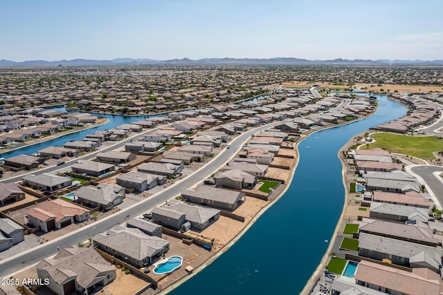 birds eye view of property with a water and mountain view