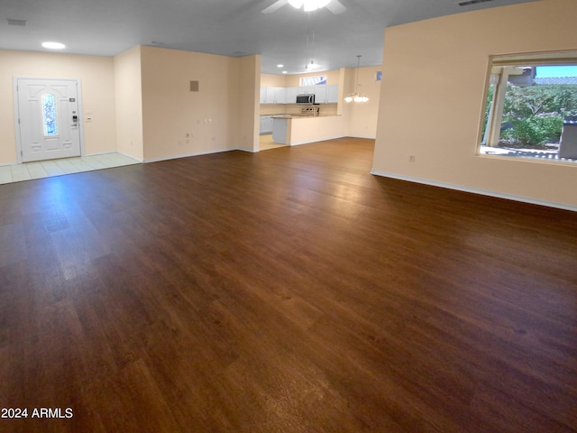 unfurnished living room with ceiling fan and light hardwood / wood-style floors