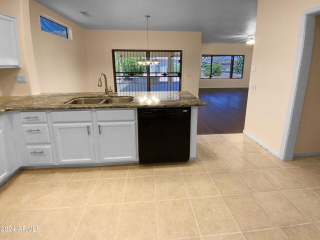 kitchen with light hardwood / wood-style flooring, white cabinets, dishwasher, sink, and decorative light fixtures