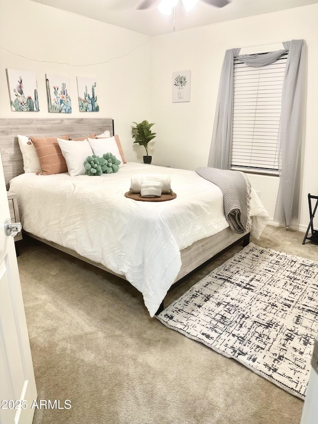 bedroom with ceiling fan and carpet flooring