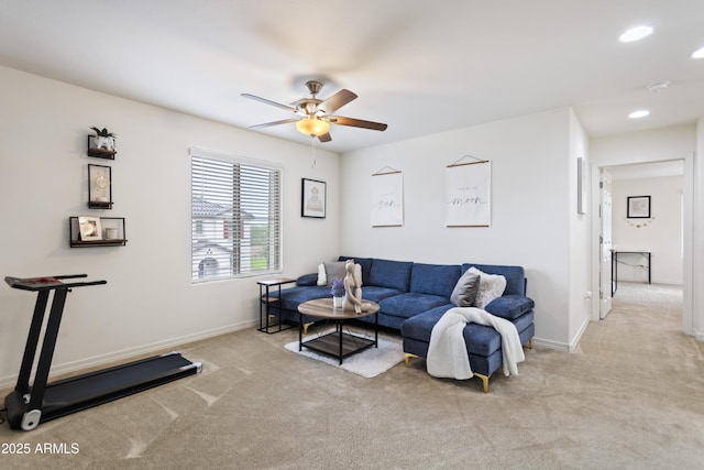 carpeted living room featuring ceiling fan