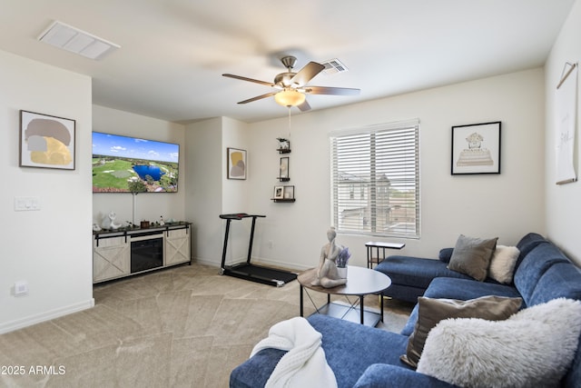 living room featuring ceiling fan and light colored carpet