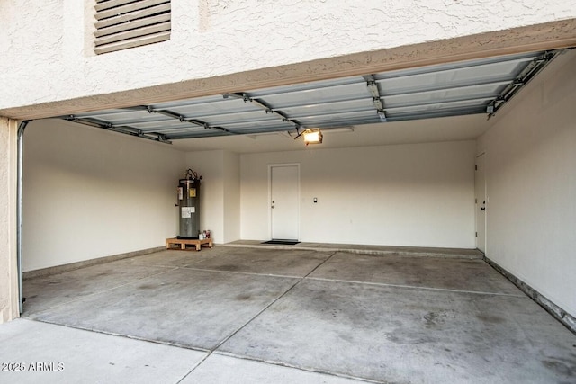 garage featuring a garage door opener and electric water heater