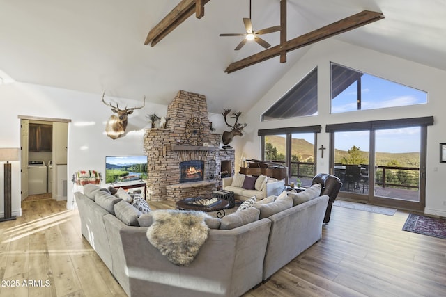 4562 N Dream Catcher Way, Pine, AZ 85544 - living area with a fireplace, beam ceiling, high vaulted ceiling, light wood-style floors, and a ceiling fan