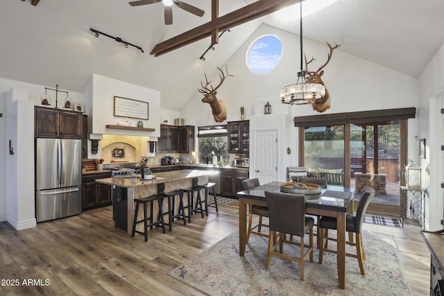 4562 N Dream Catcher Way, Pine, AZ 85544 - dining room featuring track lighting, high vaulted ceiling, wood finished floors, ceiling fan, and beam ceiling
