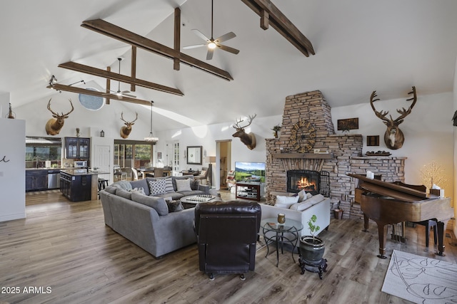 4562 N Dream Catcher Way, Pine, AZ 85544 - living area with ceiling fan, a fireplace, high vaulted ceiling, beamed ceiling, and wood finished floors