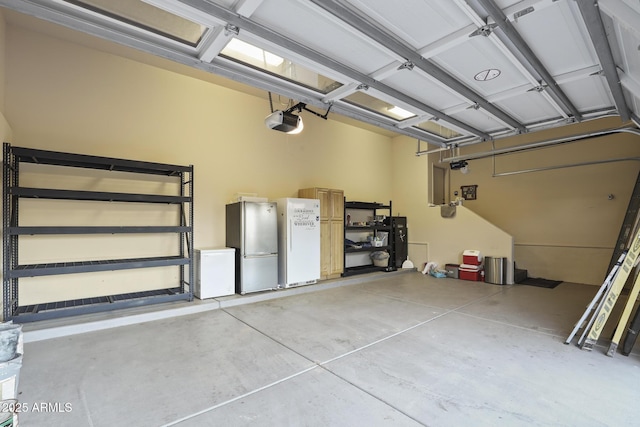 4562 N Dream Catcher Way, Pine, AZ 85544 - garage with freestanding refrigerator and a garage door opener