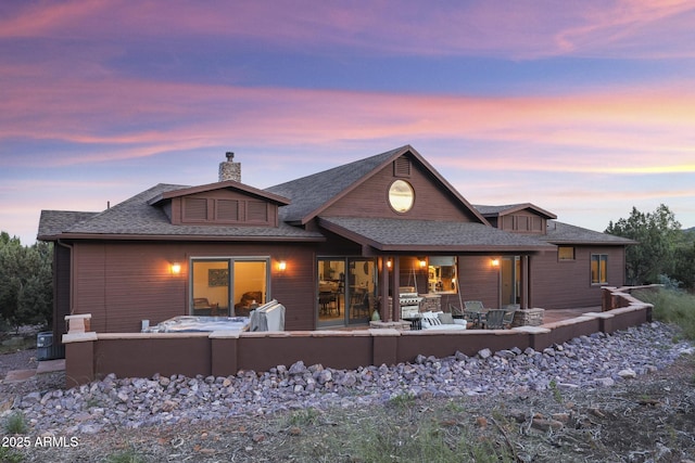 4562 N Dream Catcher Way, Pine, AZ 85544 - back of property at dusk with a chimney and a shingled roof