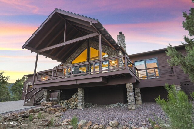 4562 N Dream Catcher Way, Pine, AZ 85544 - rear view of house with stone siding, a wooden deck, stairs, and a chimney