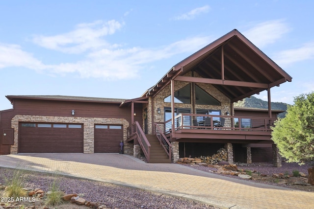 4562 N Dream Catcher Way, Pine, AZ 85544 - view of front facade with stone siding, decorative driveway, a wooden deck, and an attached garage