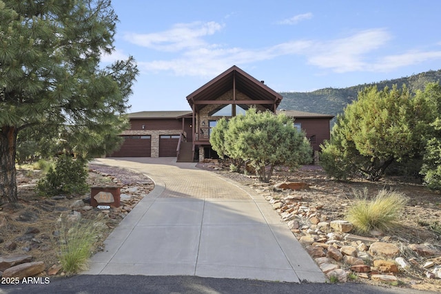 4562 N Dream Catcher Way, Pine, AZ 85544 - view of front of house with driveway, stone siding, and a mountain view
