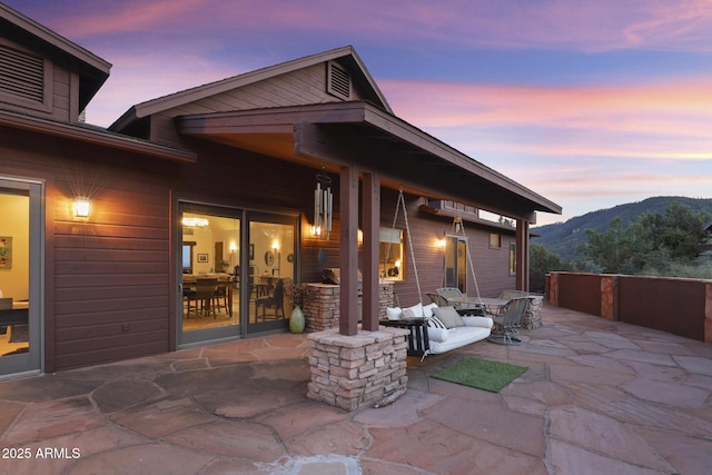 4562 N Dream Catcher Way, Pine, AZ 85544 - patio terrace at dusk featuring a mountain view and a patio