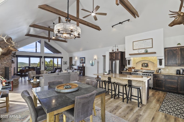 4562 N Dream Catcher Way, Pine, AZ 85544 - dining room featuring ceiling fan, high vaulted ceiling, beam ceiling, a chandelier, and light wood-type flooring