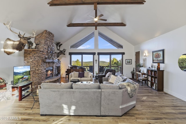4562 N Dream Catcher Way, Pine, AZ 85544 - living room with high vaulted ceiling, beamed ceiling, a fireplace, a ceiling fan, and wood finished floors