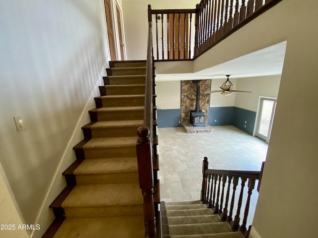 19322 E Calle De Flores, Queen Creek, AZ 85142 - stairs featuring a wood stove, a high ceiling, a ceiling fan, and stone finish floor