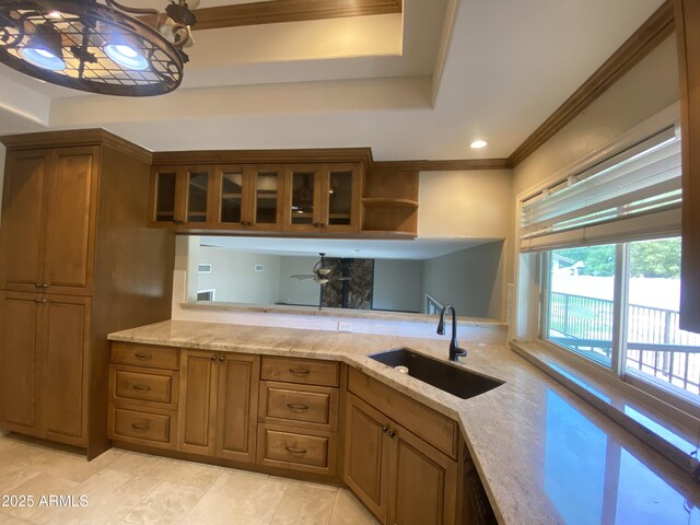 19322 E Calle De Flores, Queen Creek, AZ 85142 - kitchen featuring a ceiling fan, brown cabinets, a raised ceiling, and a sink