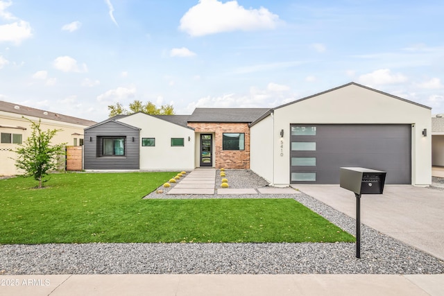 modern home featuring concrete driveway, an attached garage, brick siding, and a front yard