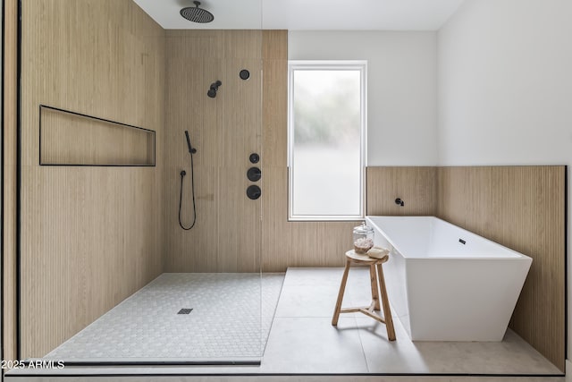 bathroom featuring a tile shower and a freestanding bath