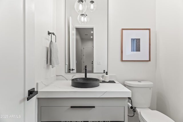 bathroom with toilet and vanity