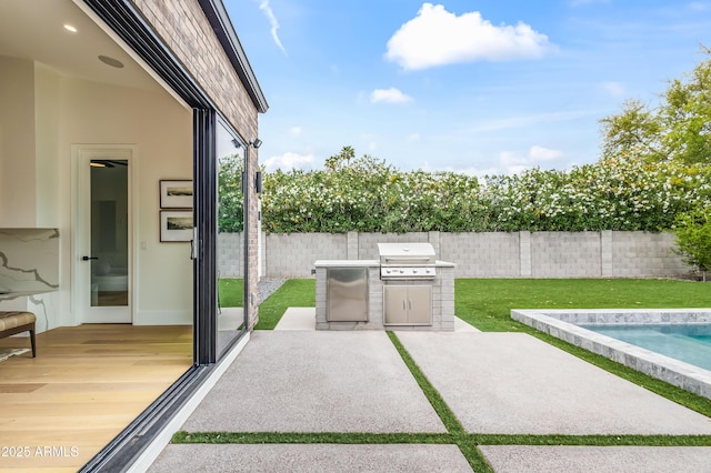 view of patio with a fenced backyard, a grill, and a fenced in pool