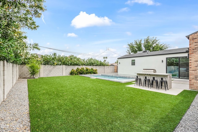 view of yard featuring a patio area, a fenced backyard, a fenced in pool, and outdoor dry bar