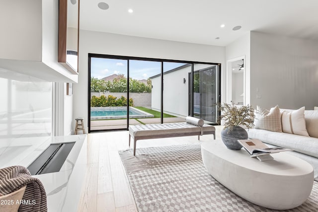 living area featuring wood-type flooring and recessed lighting
