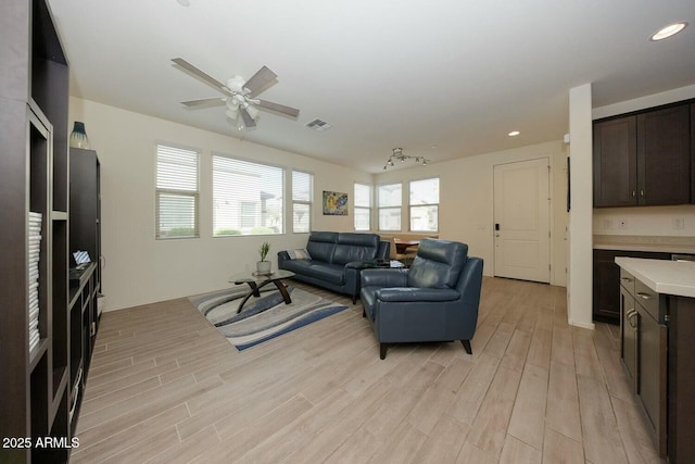 living room with ceiling fan and light hardwood / wood-style floors