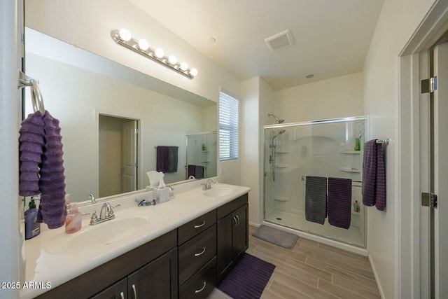 bathroom featuring walk in shower and vanity