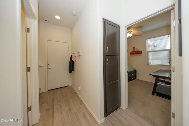 hall with light wood-type flooring