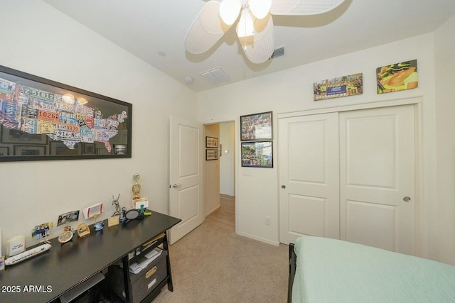 carpeted bedroom featuring ceiling fan and a closet