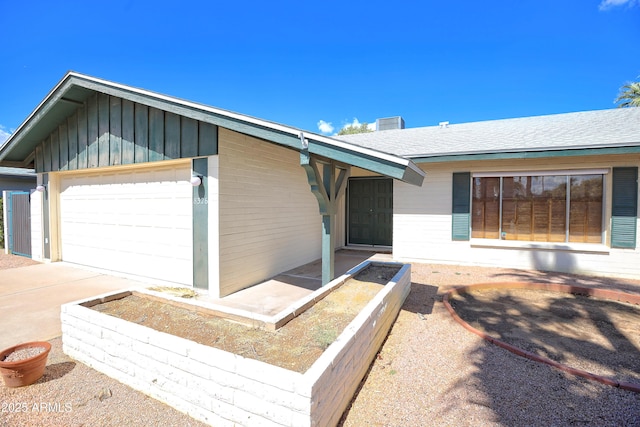 8326 E Valley View Rd, Scottsdale, AZ 85250 - view of front of home with board and batten siding, a garage, concrete driveway, and a shingled roof